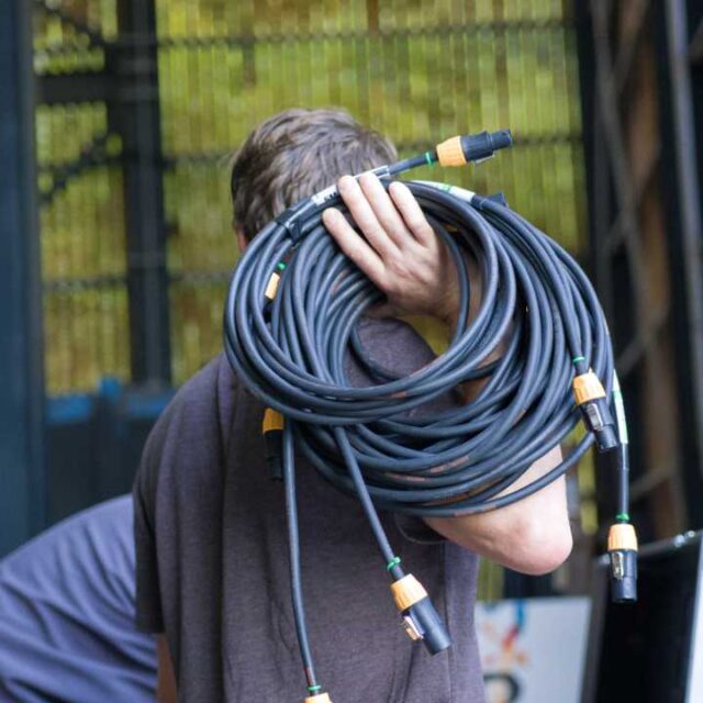 Photo of a person carrying cables